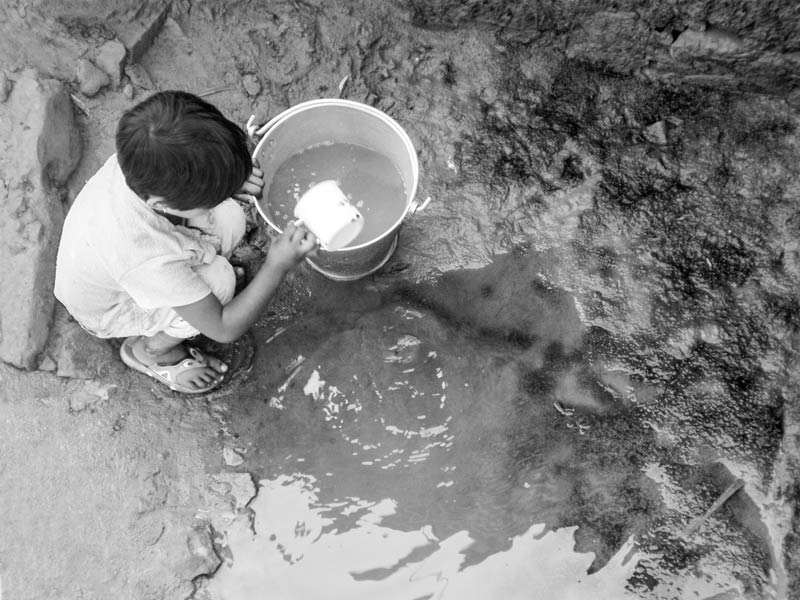 Human Right to Water in India - Collecting scanty but unclean drinking water from an unprotected source in Mon district, Nagaland